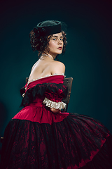 Image showing Young woman as Anna Karenina on dark blue background. Retro style, comparison of eras concept.