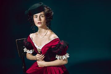 Image showing Young woman as Anna Karenina on dark blue background. Retro style, comparison of eras concept.