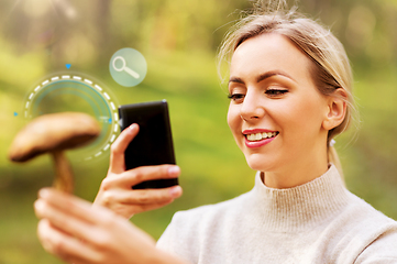 Image showing woman using smartphone to identify mushroom