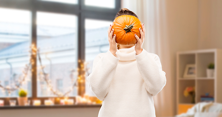 Image showing woman holding pumpkin and covering her face