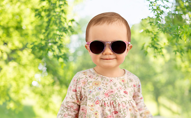 Image showing happy little baby girl in sunglasses over nature