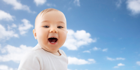 Image showing portrait of happy laughing little baby over sky