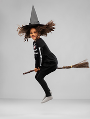 Image showing girl in black witch hat with broom on halloween