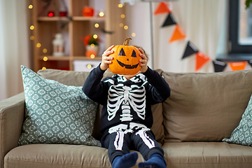 Image showing boy in halloween costume with jack-o-lantern