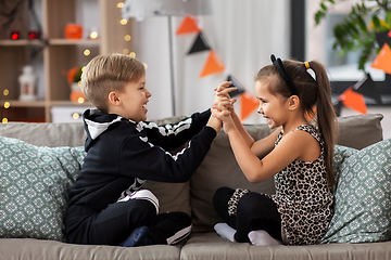 Image showing kids in halloween costumes having fun at home