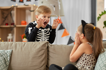 Image showing kids in halloween costumes playing at home