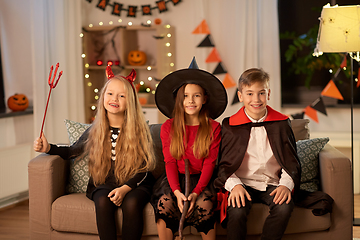 Image showing kids in halloween costumes at home at night