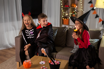 Image showing kids in halloween costumes playing at home