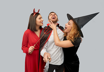 Image showing happy friends in halloween costumes taking selfie