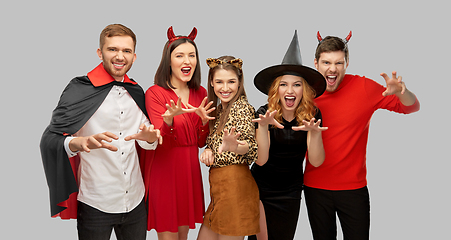 Image showing friends in halloween costumes scaring