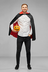 Image showing man in halloween costume of vampire with pumpkin