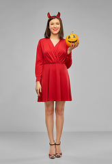 Image showing woman in halloween costume of devil with pumpkin