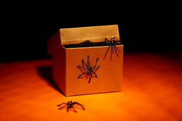 Image showing toy spiders crawling out of gift box on halloween
