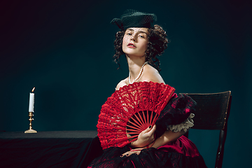 Image showing Young woman as Anna Karenina on dark blue background. Retro style, comparison of eras concept.