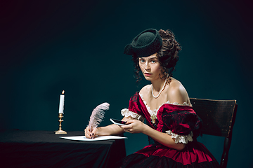 Image showing Young woman as Anna Karenina on dark blue background. Retro style, comparison of eras concept.