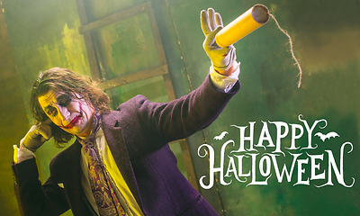 Image showing Young man as a Joker on green background, halloween time, flyer with copyspace