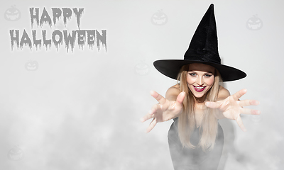 Image showing Young woman a witch on scary background