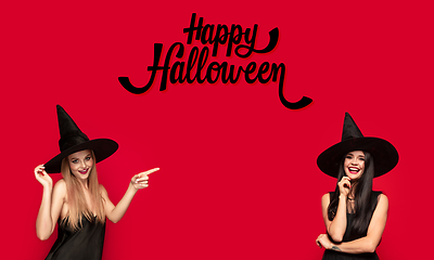 Image showing Young attrective women in hat as a witch on scary background