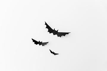 Image showing flock of black paper bats over white background