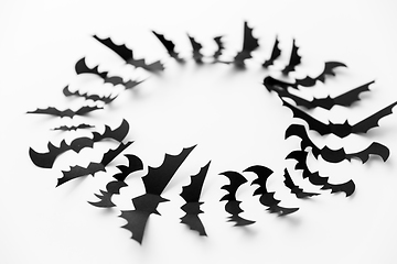 Image showing flock of black paper bats over white background