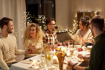 Image showing happy friends having christmas dinner at home