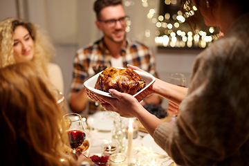 Image showing happy friends having christmas dinner at home