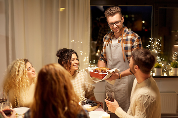 Image showing happy friends having christmas dinner at home