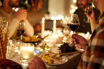 Image showing friends drinking red wine at christmas party