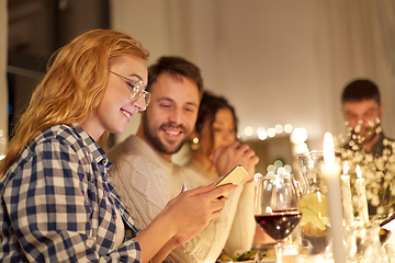 Image showing friends with cellphone having dinner party at home