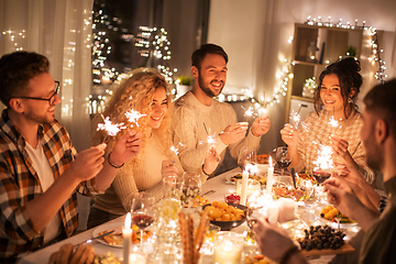 Image showing happy friends having christmas dinner at home