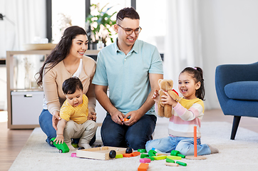 Image showing happy family palying with wooden toys at home