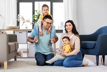 Image showing portrait of happy family sitting on floor at home