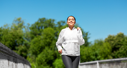 Image showing african american woman running outdoors