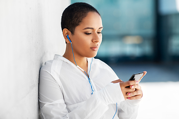 Image showing african american woman with earphones and phone