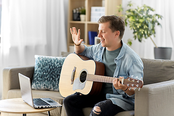 Image showing man with laptop and guitar having video call