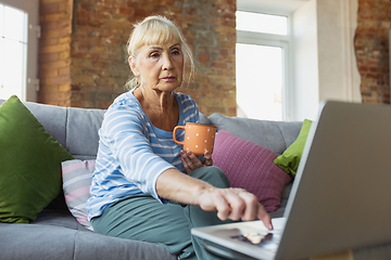 Image showing Senior woman studying at home, getting online courses