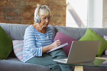 Image showing Senior woman studying at home, getting online courses