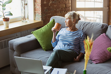 Image showing Senior woman studying at home, getting online courses