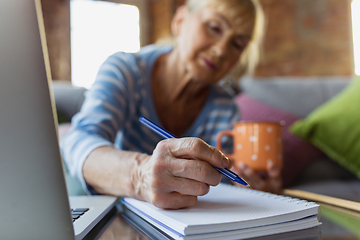 Image showing Senior woman studying at home, getting online courses