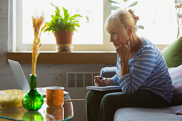 Image showing Senior woman studying at home, getting online courses