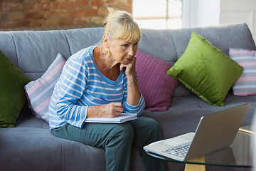 Image showing Senior woman studying at home, getting online courses