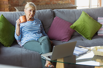 Image showing Senior woman studying at home, getting online courses