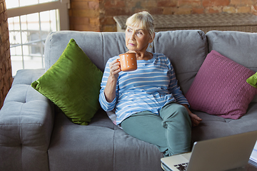 Image showing Senior woman studying at home, getting online courses