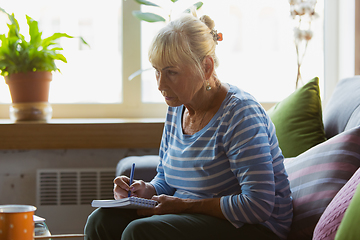 Image showing Senior woman studying at home, getting online courses