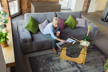 Image showing Senior woman studying at home, getting online courses