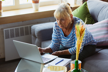 Image showing Senior woman studying at home, getting online courses