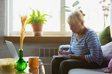 Image showing Senior woman studying at home, getting online courses