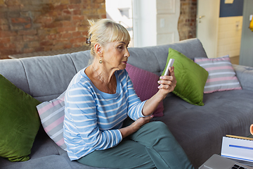 Image showing Senior woman studying at home, getting online courses