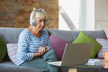 Image showing Senior woman studying at home, getting online courses