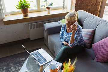 Image showing Senior woman studying at home, getting online courses